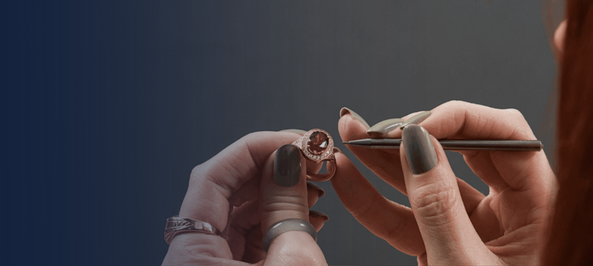 a person with red hair inspecting a piece of jewellery